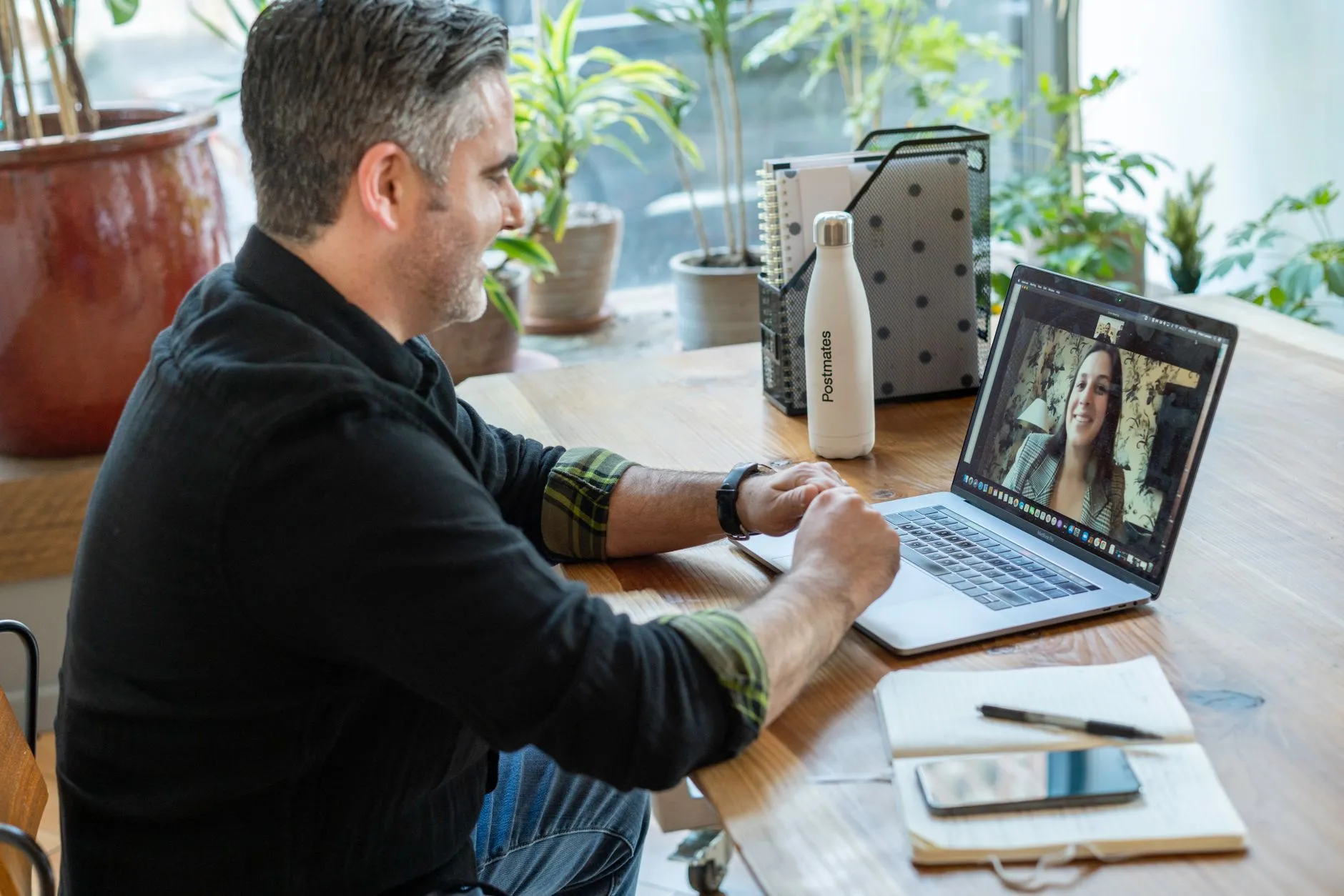 Person having a calm video therapy session on a laptop in a cosy home setting